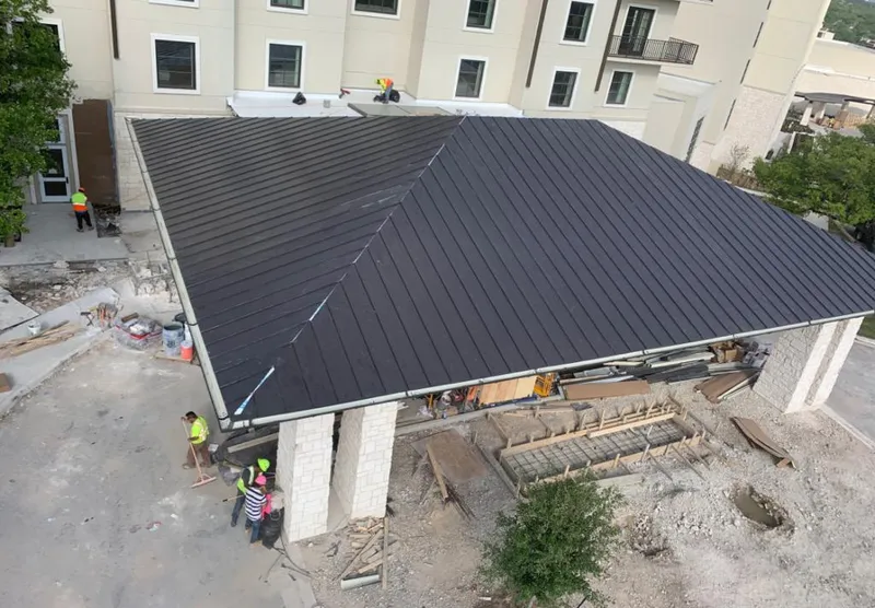 Metal roofing installation team working on a commercial building in Temple Terrace