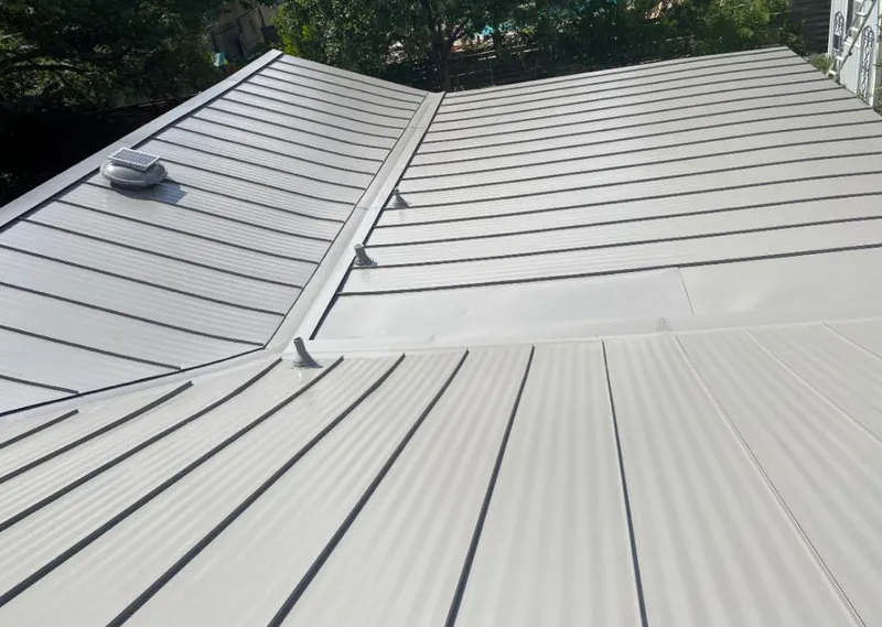 Solar attic fan installed on a metal roof for Roof Ventilation in Temple Terrace